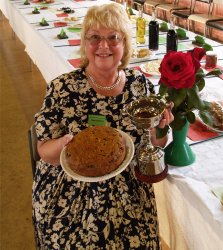 Brigitte Braod with her prize winning fruit cake and trophy for best in show rose